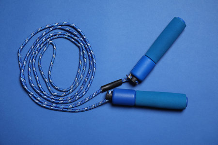 Skipping rope on blue background, top viewの写真素材