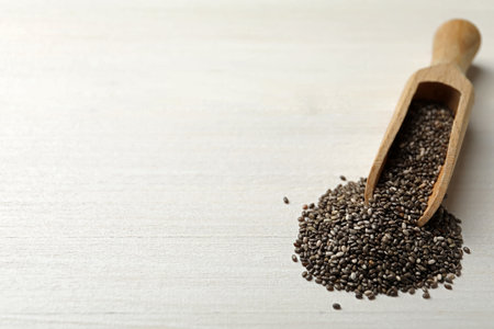 Scoop with chia seeds on white wooden table. Space for textの写真素材