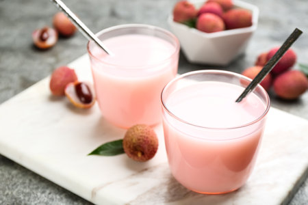 Delicious lychee cocktails and fresh fruits on white marble boardの写真素材