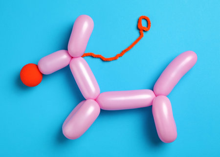Dog figure made of modeling balloon on light blue background, top viewの写真素材