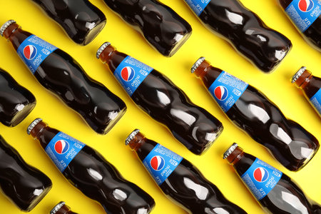 MYKOLAIV, UKRAINE - FEBRUARY 08, 2021: Glass bottles of Pepsi on yellow background, flat layのeditorial素材