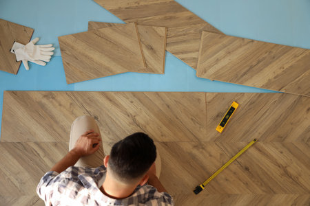 Professional worker installing new parquet flooring indoors, top viewの写真素材