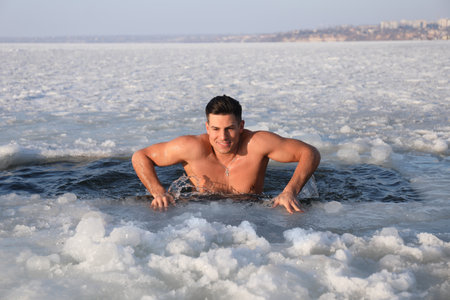 Man immersing in icy water on winter day. Baptist ritualの写真素材