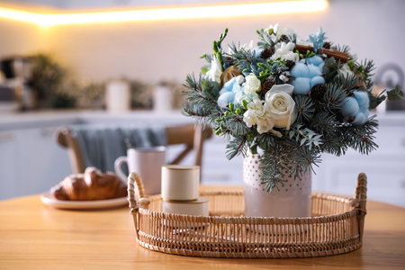 Beautiful winter bouquet on wooden table in kitchenの写真素材