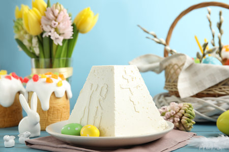 Traditional cottage cheese Easter paskha on light blue wooden table