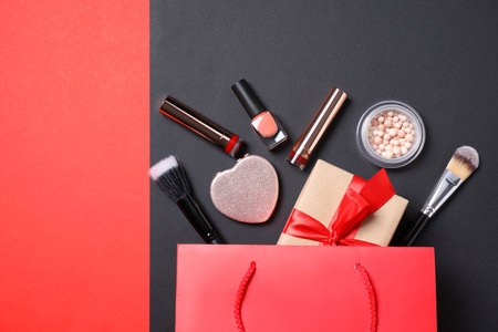 Flat lay composition with makeup products and gift box on color backgroundの写真素材