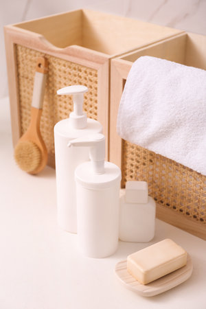 Toiletries and personal hygiene products on white table in bathroomの写真素材