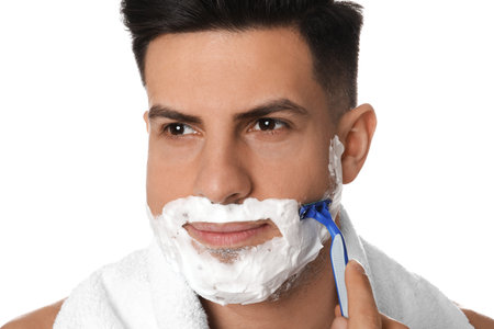 Handsome man shaving with razor on white background, closeupの写真素材
