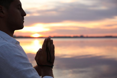 Man near river at sunset, space for text. nature healing powerの写真素材