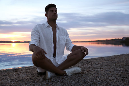 Man near river at sunset, space for text. nature healing powerの写真素材