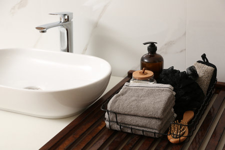 Personal hygiene products and toiletries near the sink in the bathroomの写真素材