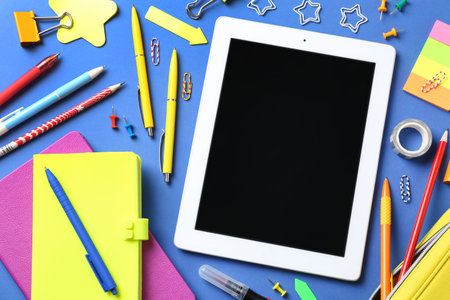 Flat lay composition with tablet on blue backgroundの写真素材