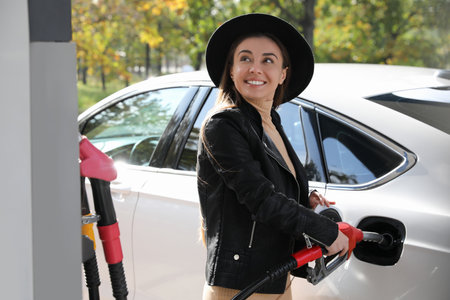 Woman refueling car at self service gas stationの写真素材