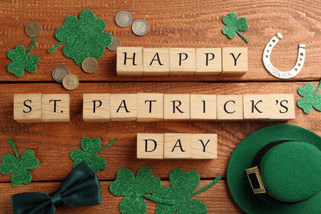 Words Happy St. Patrick's day and festive decor on wooden background, flat layの写真素材