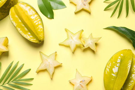 Delicious carambola fruits on yellow background, flat layの写真素材