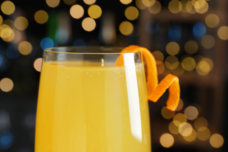 Mimosa cocktail with garnish against blurred lights, closeupの写真素材