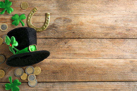 Leprechaun's hat and St. Patrick's day decor on wooden background, flat lay. Space for textの写真素材