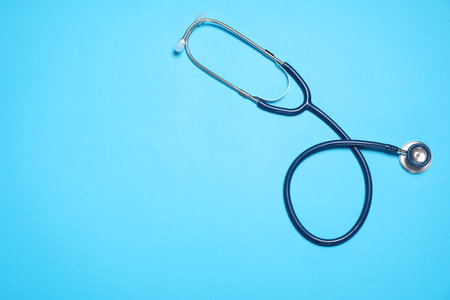 Modern stethoscope on light blue background, top view. Space for textの写真素材