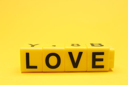 Cubes with word LOVE on yellow backgroundの写真素材