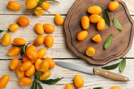 Fresh ripe kumquats on white wooden table, flat layの写真素材