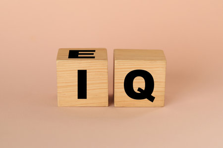 Wooden cubes with abbreviation IQ on gray backgroundの写真素材