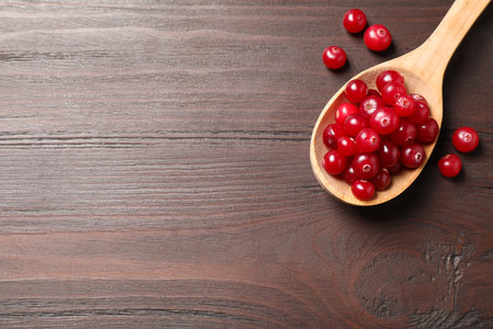 Fresh cranberry on wooden table, flat lay. Space for textの写真素材