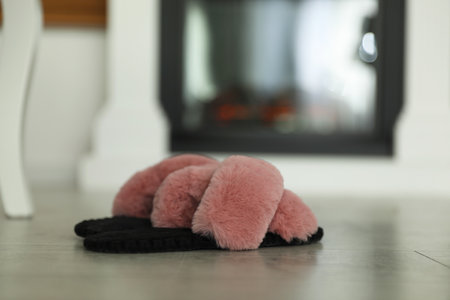 Fluffy women's slippers on floor in roomの写真素材