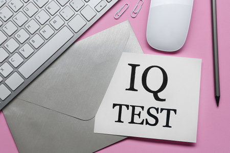 Note with text IQ Test, envelope, pencil, keyboard and mouse on pink background, flat layの写真素材