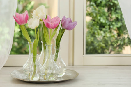 Beautiful fresh tulips on window sill indoors. spring flowersの写真素材