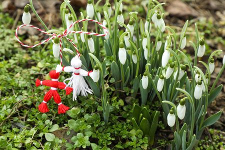 Traditional martisor and beautiful snowdrops outdoors. Symbol of first spring dayの写真素材
