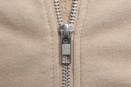 Beige sweatshirt with zipper as background, top viewの写真素材