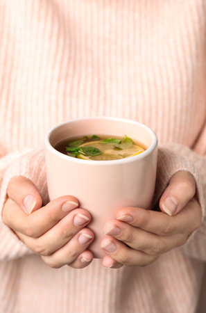 Woman holding cup with hot tea, closeupの写真素材