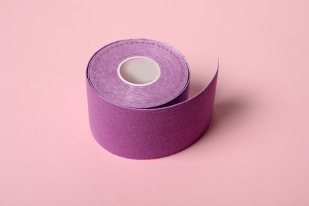 Bright kinesio tape in roll on pink backgroundの写真素材
