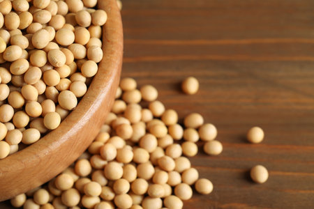 Bowl with soy on wooden table, closeup. Space for textの写真素材