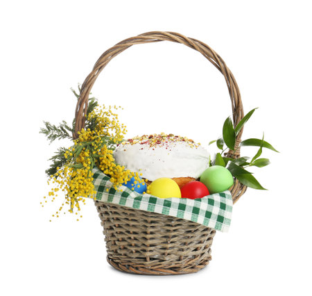 Basket with delicious Easter cake, dyed eggs and flowers on white backgroundの写真素材