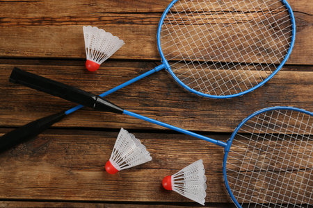 Rackets and shuttlecocks on wooden table, flat lay. badminton equipmentの写真素材