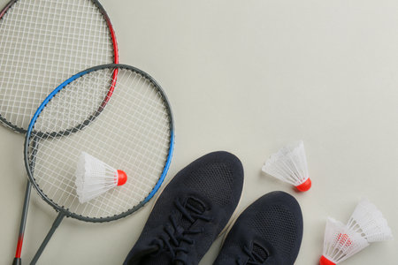 Badminton rackets, shuttlecocks and shoes on light gray background, flat lay. Space for textの写真素材