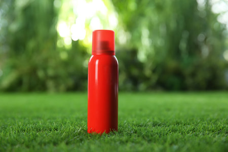 Bottle of insect repellent spray on green grass. Space for textの写真素材