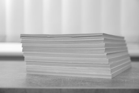 Stack of paper sheets on gray table, closeupの写真素材