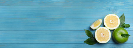 Fresh ripe sweeties on blue wooden table, flat lay with space for text. banner design