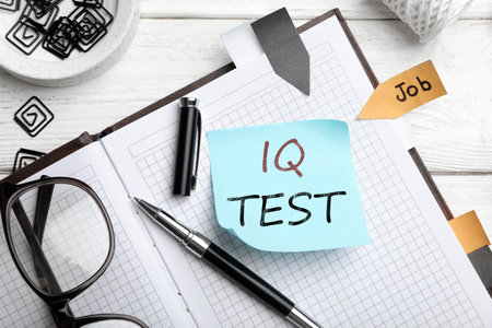 Sticky note with text IQ Test and stationery on table, flat layの写真素材