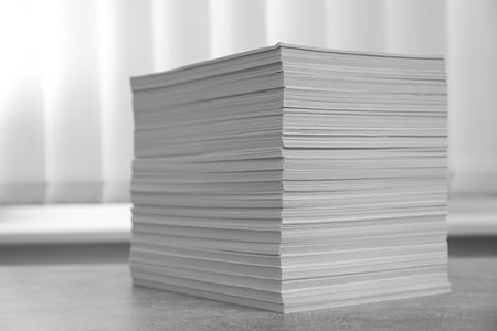Stack of paper sheets on gray table