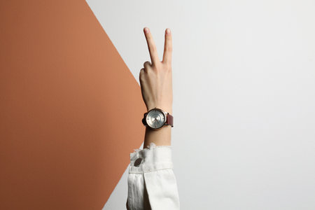 Woman wearing luxury wrist watch on color background, closeupの写真素材