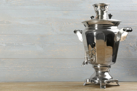 Traditional Russian samovar on wooden table. Space for textの写真素材