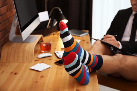 Businessman in jacket and underwear near computer at home office, closeupの写真素材