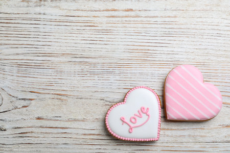 Heart shaped cookies on white wooden table, flat lay with space for text. Valentine's day treatの写真素材