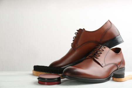 Shoe care products and footwear on white table. Space for textの写真素材