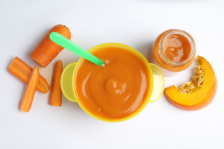 Flat lay composition with healthy baby food and ingredients on white backgroundの写真素材