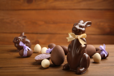 Chocolate Easter bunny and eggs on wooden table. Space for textの写真素材