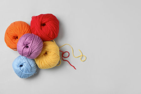 Soft woolen yarns on white background, flat lay. Space for textの写真素材